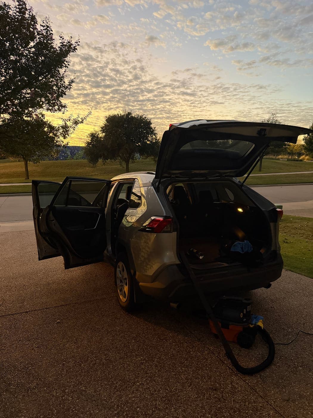SUV with doors and hatch open during an evening interior detail