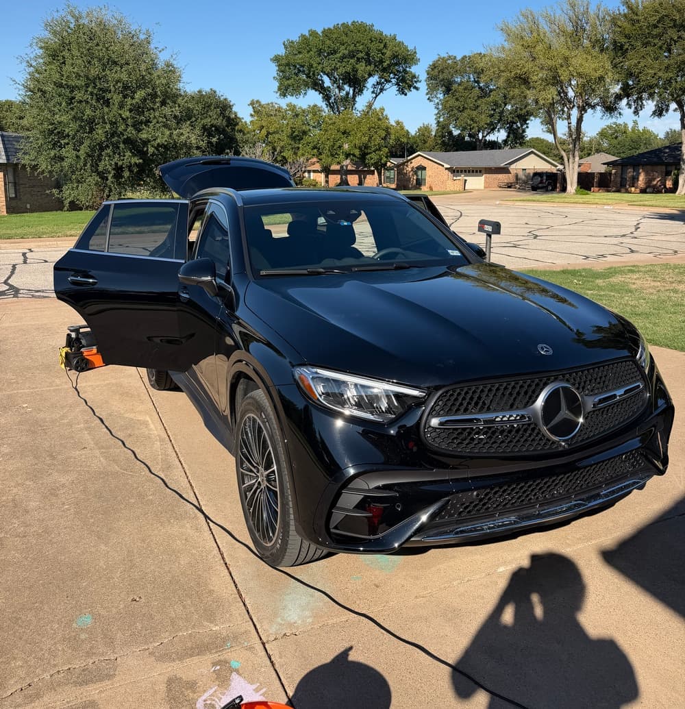 Freshly detailed black Mercedes-Benz SUV parked in a Texas driveway